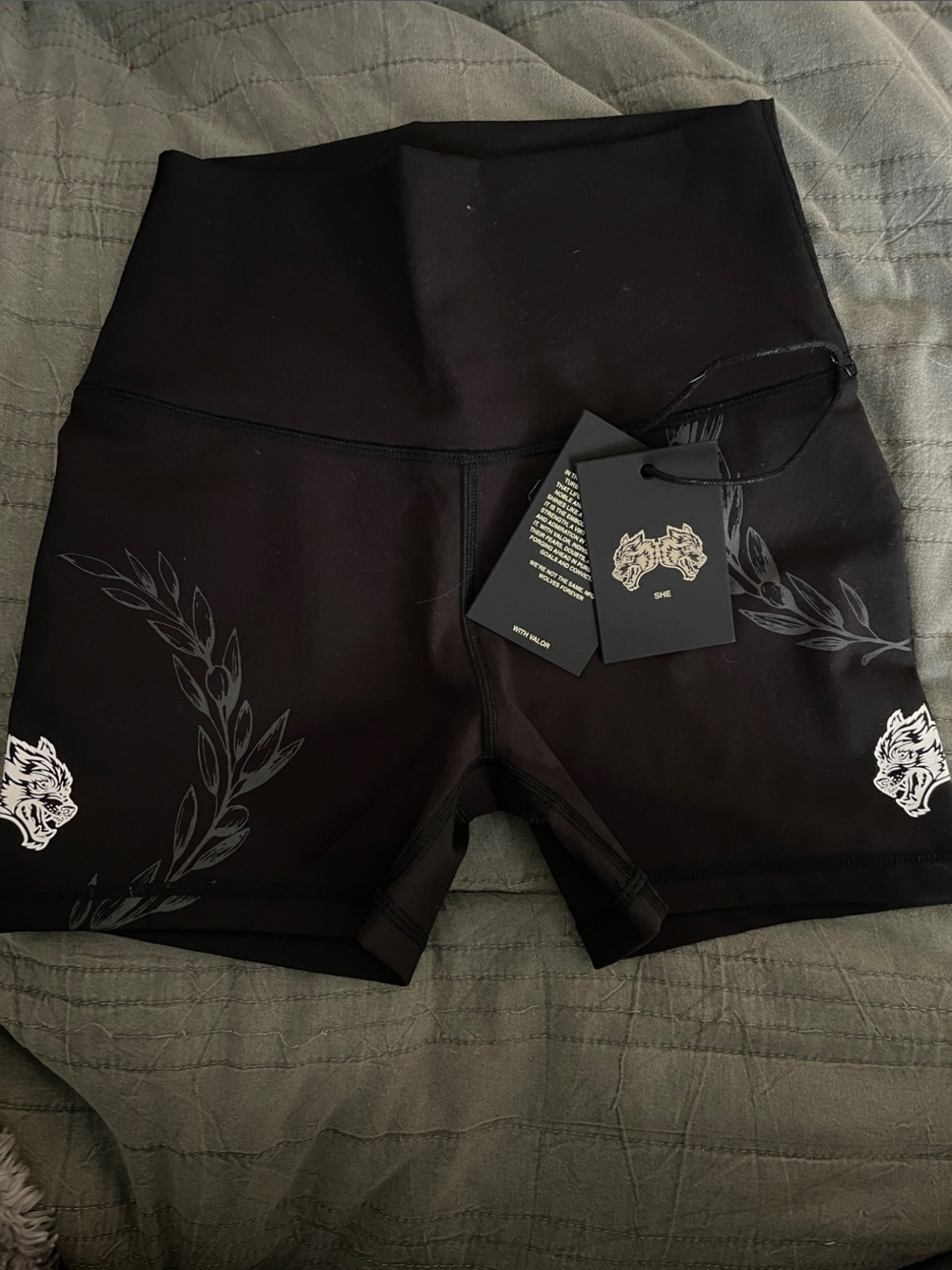 SHEFIT Black High-Waist Athletic Shorts with Subtle Gray Leaf and White Accent